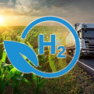 A hydrogen truck and corn field are shown with a symbol for hydrogen.