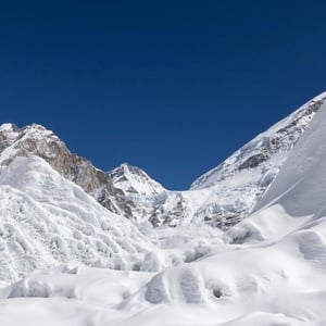 Photo of high mountains with heavy snowpack.