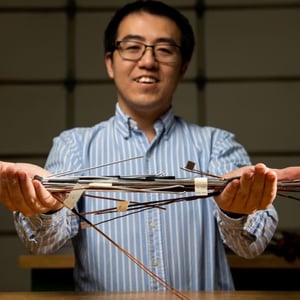 Photo of a researcher holding copper wire samples